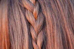 Close up image of light brown hair with simple braid down the centre of the hair. Illustrating natural full bodied volume that can be achieved with LUSHIERE CLIP IN HAIR EXTENSIONS