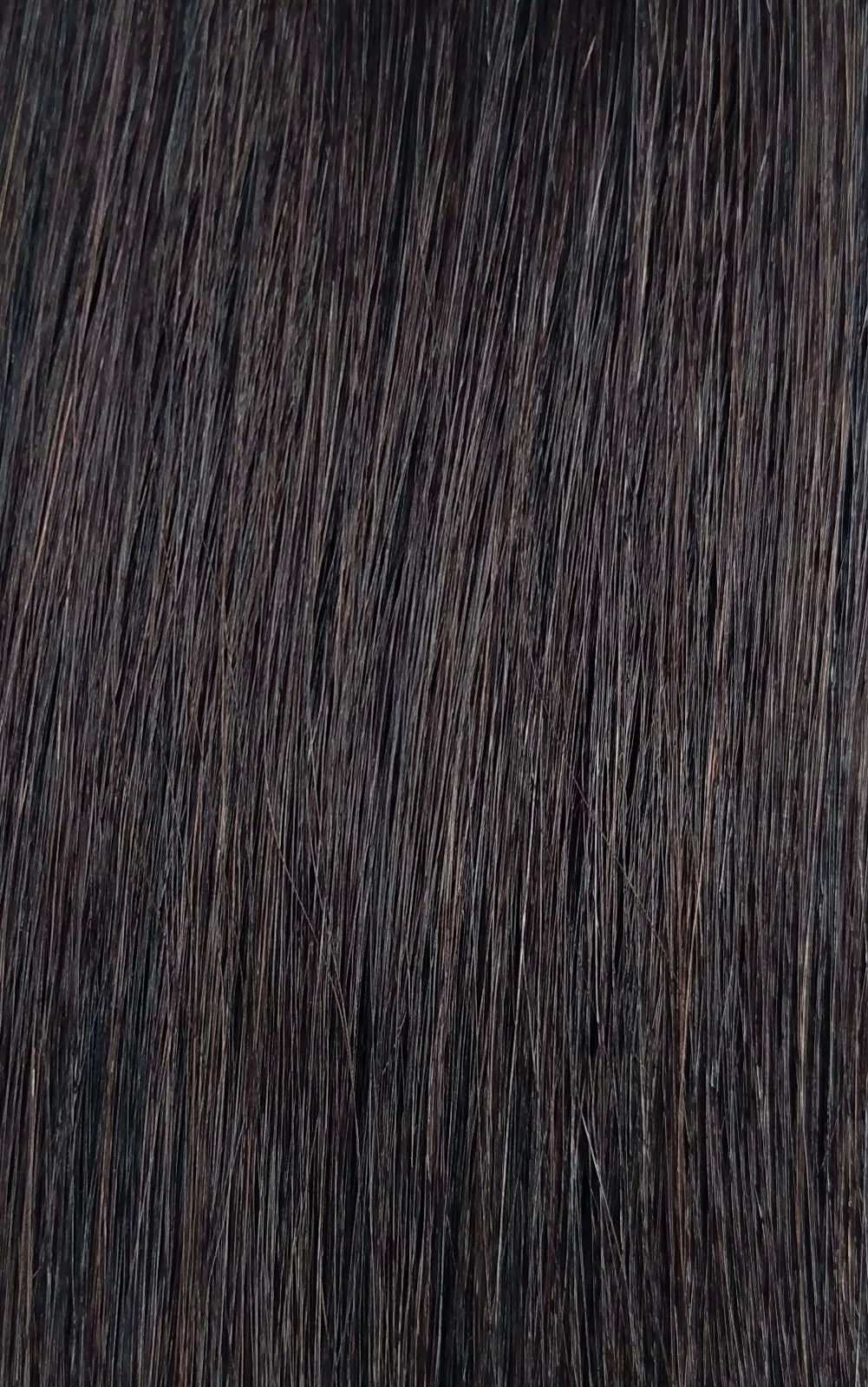 Close up image of LUSHIERE clip in hair extensions in very dark brown colour #2d Deep Dark Brown taken in natural light