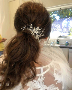 Image of bride from behind with thick low ponytail achieved with LUSHIERE clip in hair extensions and wearing hair accessories 